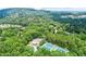 An aerial view of the community featuring the pool and tennis courts nestled among lush green trees at 4295 Parish Trce, Marietta, GA 30066