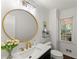Stylish bathroom with a modern vanity, round mirror, and natural light from the window at 4295 Parish Trce, Marietta, GA 30066