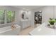 Bright bathroom with a modern tub, dual vanities, and access to a walk-in closet at 4295 Parish Trce, Marietta, GA 30066