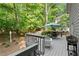 Outdoor deck with patio seating and a grill, perfect for entertaining and enjoying nature at 4295 Parish Trce, Marietta, GA 30066