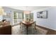 Dining room featuring hardwood floors, a large window, blue walls, and classic decorative furniture at 4295 Parish Trce, Marietta, GA 30066