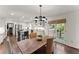 Dining room with a rustic table, chandelier, and easy access to kitchen and screened porch at 4295 Parish Trce, Marietta, GA 30066