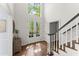 Bright, sunlit foyer featuring hardwood floors, glass paned door, and a staircase with a wood handrail at 4295 Parish Trce, Marietta, GA 30066