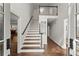 Inviting foyer featuring hardwood floors, staircase with a wood handrail, and views to other living spaces at 4295 Parish Trce, Marietta, GA 30066