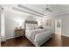 This main bedroom offers a tray ceiling, ceiling fan, hardwood floors and neutral decor at 4295 Parish Trce, Marietta, GA 30066