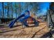 Community playground area with a blue slide, mulch ground cover, and a nearby staircase at 4295 Parish Trce, Marietta, GA 30066