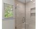 Updated tile shower features a glass door and window with a view at 4295 Parish Trce, Marietta, GA 30066