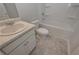 Bathroom featuring a single sink vanity, toilet, and shower-tub combo at 502 Charleston Pl, Villa Rica, GA 30180