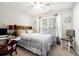 Bedroom featuring carpet floors, a bed with pillows, curtains, and a chair at 3140 Willow Park Dr, Dacula, GA 30019