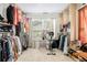Spacious walk-in closet with ample clothing racks, shelving, a window, and an exercise machine at 3140 Willow Park Dr, Dacula, GA 30019