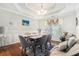 Elegant dining room with tray ceiling, hardwood floors, and comfortable seating for six at 3140 Willow Park Dr, Dacula, GA 30019