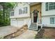 Inviting front entrance featuring a decorative door, stone accents, and landscaped walkway at 3140 Willow Park Dr, Dacula, GA 30019
