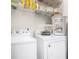 Functional laundry area equipped with a washer and dryer, along with convenient overhead shelving at 3140 Willow Park Dr, Dacula, GA 30019