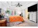 Bright main bedroom showcasing a tray ceiling, a king bed, and french doors to the backyard at 3140 Willow Park Dr, Dacula, GA 30019