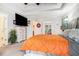 Bright main bedroom featuring a tray ceiling, a large television, and neutral-toned walls at 3140 Willow Park Dr, Dacula, GA 30019