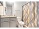 Bathroom with grey cabinets, granite countertops and decorative shower curtain at 328 Orchid Dr, Mcdonough, GA 30252