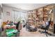 Spacious bedroom with a large bookcase, desk area, and exercise equipment near a bright window at 328 Orchid Dr, Mcdonough, GA 30252