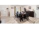 Bright dining room with hardwood floors, a wooden table, and ample natural light at 328 Orchid Dr, Mcdonough, GA 30252