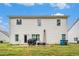 Back of a two story home with white siding, ladder, and multiple windows overlooking a lush green lawn at 328 Orchid Dr, Mcdonough, GA 30252