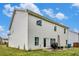 Back of a two story home with white siding, ladder, multiple windows, and well maintained lawn at 328 Orchid Dr, Mcdonough, GA 30252