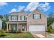 Beautiful two-story brick home featuring a cozy front porch and attached two-car garage at 328 Orchid Dr, Mcdonough, GA 30252