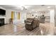 Open-concept living space with hardwood floors, a fireplace, and modern furnishings at 328 Orchid Dr, Mcdonough, GA 30252