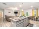 Open floor plan featuring a kitchen island with a sink and view to the living room at 328 Orchid Dr, Mcdonough, GA 30252