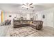 Open living area with hardwood floors, a sectional sofa, and an adjoining kitchen at 328 Orchid Dr, Mcdonough, GA 30252