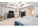 Primary bedroom featuring tray ceiling, ceiling fan, neutral carpet and ensuite bath at 328 Orchid Dr, Mcdonough, GA 30252