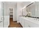 Bright bathroom featuring white double vanity with quartz countertops and a large walk-in shower with glass door at 613 Stickley Oak Way, Woodstock, GA 30189
