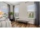 Bedroom showcasing large windows dressed with neutral drapes, providing ample natural light at 613 Stickley Oak Way, Woodstock, GA 30189