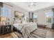 Spacious primary bedroom features beautiful wood floors, large windows, and tasteful decor at 613 Stickley Oak Way, Woodstock, GA 30189