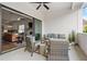 Spacious covered patio with plush seating, fan, and direct access to indoor living spaces at 613 Stickley Oak Way, Woodstock, GA 30189