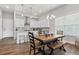 Eat-in kitchen and dining area features wood floors, dining table, and window with natural light at 613 Stickley Oak Way, Woodstock, GA 30189