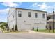 Modern two-story home showcasing a clean white facade, individual garages, and well-maintained landscaping at 613 Stickley Oak Way, Woodstock, GA 30189
