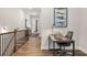 Upstairs hallway showcases a functional desk space and elegant railing with wood flooring at 613 Stickley Oak Way, Woodstock, GA 30189