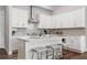 Modern kitchen with white cabinetry, stainless steel appliances, and center island with bar stool seating at 613 Stickley Oak Way, Woodstock, GA 30189