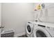 Functional laundry room with modern washer and dryer, wire shelving, and gray accents at 613 Stickley Oak Way, Woodstock, GA 30189