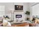 Bright living room with fireplace, large windows, and comfortable seating for relaxing and entertaining at 613 Stickley Oak Way, Woodstock, GA 30189