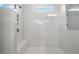 Modern shower with white subway tile, frameless glass door, built-in bench and niche for toiletries at 613 Stickley Oak Way, Woodstock, GA 30189