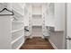 Spacious walk-in closet with custom shelving and ample storage for organization and convenience at 613 Stickley Oak Way, Woodstock, GA 30189