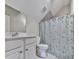 Stylish bathroom featuring a sink, toilet, and patterned shower curtain at 215 Haleys Ct, Woodstock, GA 30188
