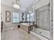 Bathroom featuring double vanity, modern fixtures, large tub, and a separate shower at 215 Haleys Ct, Woodstock, GA 30188