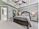 Elegant bedroom features a tray ceiling, ceiling fan, and neutral carpet at 215 Haleys Ct, Woodstock, GA 30188