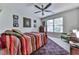 Comfortable bedroom featuring a colorful bed, large window, and a view of the backyard at 215 Haleys Ct, Woodstock, GA 30188