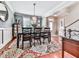 Inviting dining room showcasing decorative rug, chandelier, and natural light at 215 Haleys Ct, Woodstock, GA 30188
