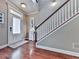Entryway features hardwood floors, a staircase with white banisters, and a decorative front door with sidelights at 215 Haleys Ct, Woodstock, GA 30188
