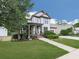 Traditional two-story home with a covered front porch, a well-kept lawn, and a paved walkway leading to the entrance at 215 Haleys Ct, Woodstock, GA 30188