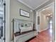 Cozy hallway featuring hardwood floors, a decorative bench, and a view into adjoining rooms at 215 Haleys Ct, Woodstock, GA 30188