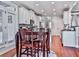 Spacious kitchen featuring a center island, dark wood table and chairs at 215 Haleys Ct, Woodstock, GA 30188